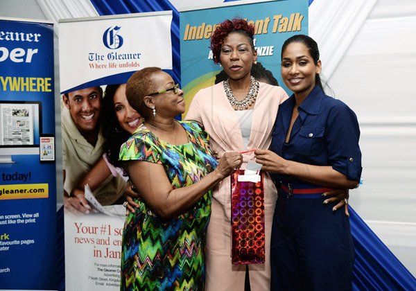 Jermaine Barnaby/Photographer
Sandra Brown-Bennett embraces Minister of Youth and Culture Lisa Hannah and retired Business Development and Marketing Manager, Karin Cooper as she receives her award at The Gleaner’s Annual Sales Awards Breakfast at the Jamaica Pegasus Hotel, Legacy Suite 81 Knutsford Boulevard, Kingston on Monday, January 18, 2016.