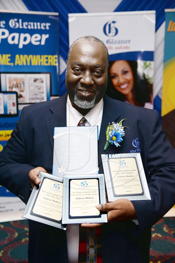 Jermaine Barnaby/Photographer
Andrew Walters, sales representative of the year, poses with his collection of awards at The Gleaner’s Annual Sales Awards Breakfast at the Jamaica Pegasus Hotel, Legacy Suite 81 Knutsford Boulevard, Kingston on Monday, January 18, 2016.
