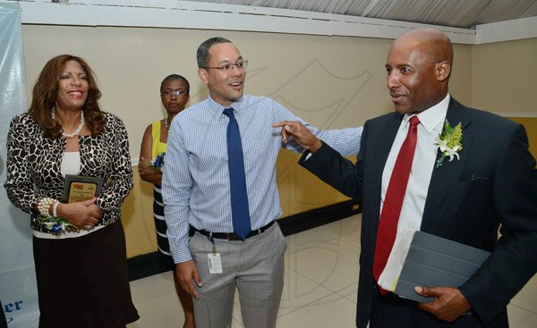 Rudolph Brown/Photographer
AubynHill,(right) CEO of Corporate Strategies Limited chat with Christopher Barnes Managing Director of the Gleaner Company and Esther Gordon at the Gleaner sales awards ceremony at the Terra Nova Hotel in Kingston on Monday, January 20, 2014