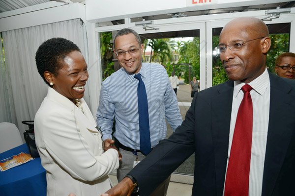 Rudolph Brown/Photographer
Christopher Barnes Managing Director of the Gleaner Company and Nordia Craig, Manager, Business Developlment and Marketing greets AubynHill, (right) CEO of Corporate Strategies Limited at the Gleaner sales awards ceremony at the Terra Nova Hotel in Kingston on Monday, January 20, 2014
