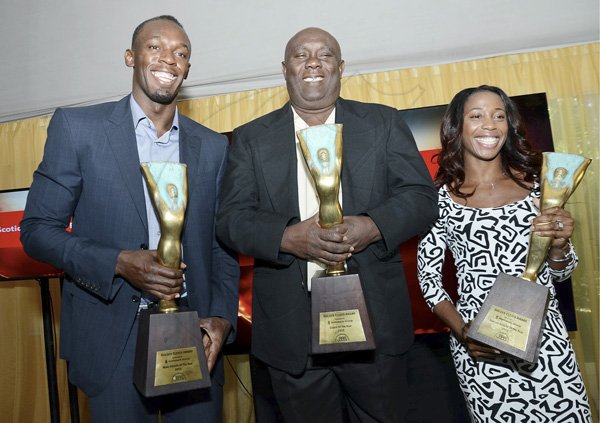 Rudolph Brown/Photographer
Glen Mills, (centre) Coach of the Year pose with Olympian Usain Bolt, Male athlete of the year and Shelly-Ann Fraser Pryce at the Scotiabank Golden Cleats Awards Luncheon at Venetian Suite, Terra Nova Hotel on Tuesday, January 8, 2013.