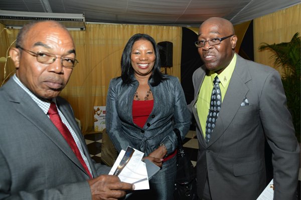 Rudolph Brown/Photographer
Dr. Warren Blake, (left)  President of JAAA chat with Ian Forbes and his Lana Forbes at the Scotiabank Golden Cleats Awards Luncheon at Venetian Suite, Terra Nova Hotel on Tuesday, January 8, 2013.