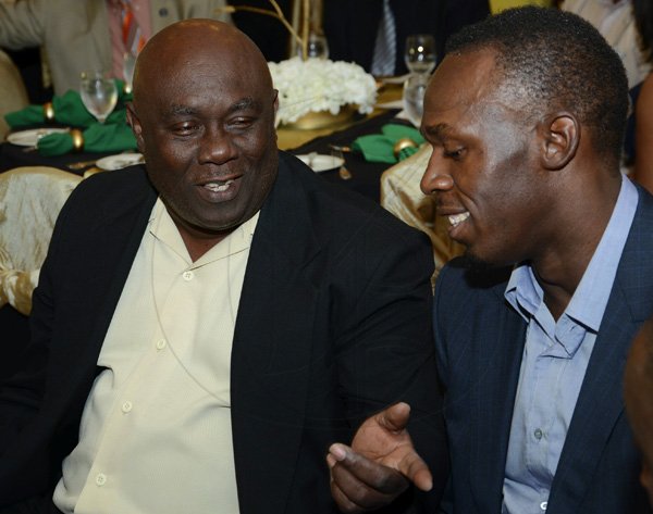 Rudolph Brown/Photographer
Glen Mills, Coach of the Year chat with Olympian Usain Bolt, Male athlete of the year at the Scotiabank Golden Cleats Awards Luncheon at Venetian Suite, Terra Nova Hotel on Tuesday, January 8, 2013.