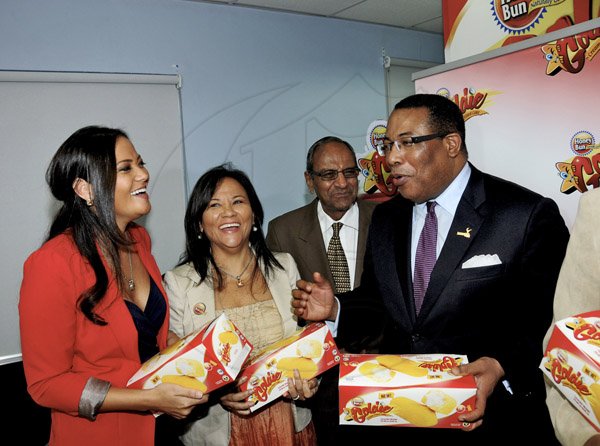 BUSINESS
Winston Sill / Freelance Photographer
Minister of Industry, Investment and Commerce Anthony Hylton (right) shares a joke with, from left, Krysatl Chong, Chief Marketing Officer, Honey Bun; Michelle Chong (second left), CEO, Honey Bun; and Sushil Jain (second right), Director, Honey Bun, at the launch of the bakery's new product, Goldie, held at the offices of Mayberry Investments Limited, Oxford Road , New Kingston on Wednesday night August 29, 2012.