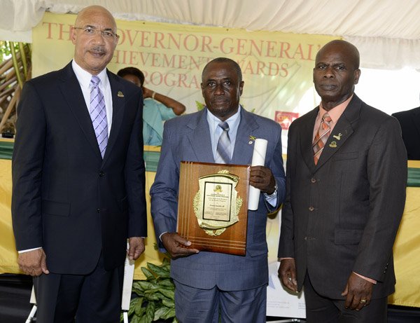 Gladstone Taylor / Photographer

l-r Sir Patrick Allen (Governer General), Cosmo Leroy Jowhill, JP (Award Recipient for the Parish of Kingston) and Hon. Steadman Fuller, CD, JP (Custos of Kingston) as seen at the Governer General's Achievement Awards held at the Whispering Bamboo Cove Resort, Morant Bay, St. Thomas