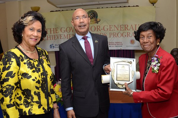 Rudolph Brown/Photographer
GG presents awward to Rev. Dr Venice Guntley-McKenzie while Custos of St. Andrew, Hon. Marigold Harding looks on at the Governor General’s Achievement Award for the County of Surrey presentation Ceremony for recipients on Thursday, September 25, 2014