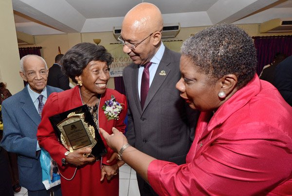Rudolph Brown/Photographer
Sir Patrick Allen, (centre) Governor General of Jamaica chat with Rev. Dr Venice Guntley-McKenzie, (second left) awardee of the Governor General award with her husband Keith McKenzie her sister Carol Guntley, (right) at the Governor-General’s Achievement Award for the County of Surrey presentation Ceremony for recipients on Thursday, September 25, 2014