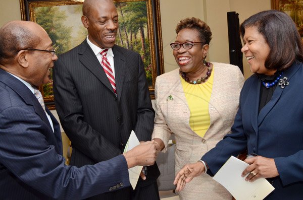 Rudolph Brown/Photographer
Police Commissioner Dr Carl Williams, (second left) chat with Dr. Henry Lowe, (left), DPP Paula Llewellyn, (second right) and Chief Justice, Hon.  Zaila McCalla at the Governor General’s Achievement Award for the County of Surrey presentation Ceremony for recipients on Thursday, September 25, 2014