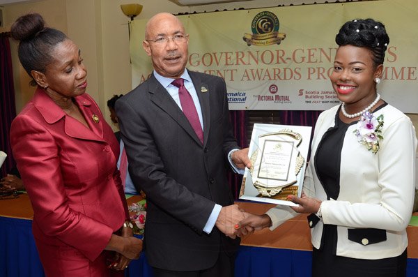 Rudolph Brown/Photographer
GG presents award to Shanese Watson while Custos of St Thomas, Hon. Marcia Bennett looks on at the Governor General’s Achievement Award for the County of Surrey presentation Ceremony for recipients on Thursday, September 25, 2014