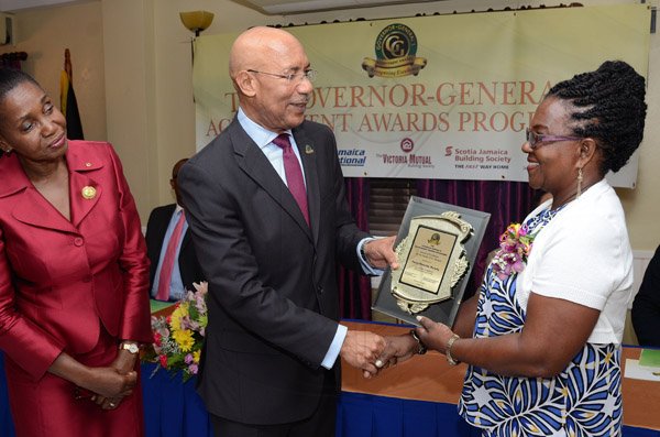 Rudolph Brown/Photographer
GG presents award to Pansy Murphy while Custos of St Thomas, Hon. Marcia Bennett looks on at the Governor General’s Achievement Award for the County of Surrey presentation Ceremony for recipients on Thursday, September 25, 2014