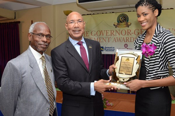 Rudolph Brown/Photographer
GG presents award to Shanique Rogers while Custos of Portland, Hon. Lincoln Thaxter looks on at the Governor General’s Achievement Award for the County of Surrey presentation Ceremony for recipients on Thursday, September 25, 2014