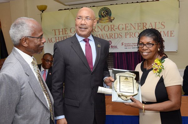 Rudolph Brown/Photographer
GG presents award to Novlet Chambers while Custos of Portland, Hon. Lincoln Thaxter looks on at the Governor General’s Achievement Award for the County of Surrey presentation Ceremony for recipients on Thursday, September 25, 2014