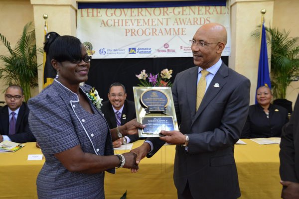 Rudolph Brown/Photographer
Governor General Sir Patrick Allen presents Pearlena Blagrove with the Jamaica 50th Jubilee Award of Excellence for Westmoreland. 
Governor General's Achievement Awards at Kings House on Tuesday, November 13, 2012