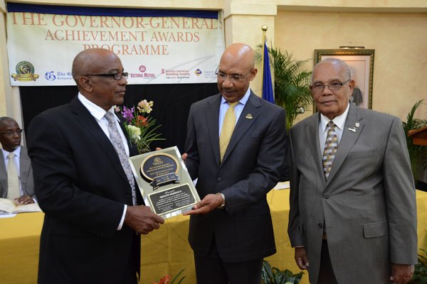 Rudolph Brown/Photographer
Governor General Sir Patrick Allen (centre) presents Adolph Murdock (left) with one of the 14 Jamaica 50th Jubilee Awards for Excellence while Custos of St Mary Bobby Pottinger looks on.

Governor General's Achievement Awards at Kings House on Tuesday, November 13, 2012