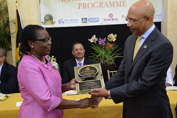 Rudolph Brown/Photographer
Governor General Sir Patrick Allen presents Annette Powell with the Jamaica 50th Jubilee Award of Excellence for Manchester. Governor General's Achievement Awards at Kings House on Tuesday, November 13, 2012
