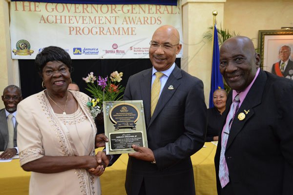 Rudolph Brown/Photographer
Governor General Sir Patrick Allen (centre) presents Aurleen Williams with the Jamaica 50th Jubilee Award for Excellence for Portland with Custos of the parish Roy Thompson looking on.

's Achievemnet Awards at Kings House on Tuesday, November 13, 2012