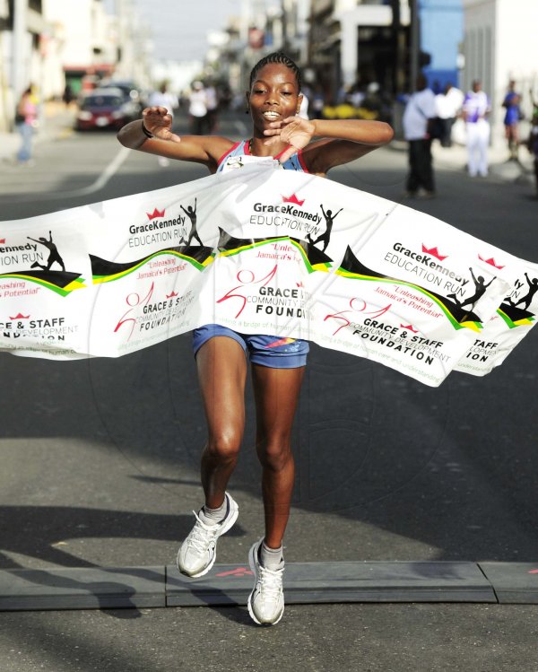 Ricardo Makyn/Staff Photographer
Juliet Dinnal First Female   runner to finish the Grace Kennedy Education Run 5K on Sunday 8.7.2012