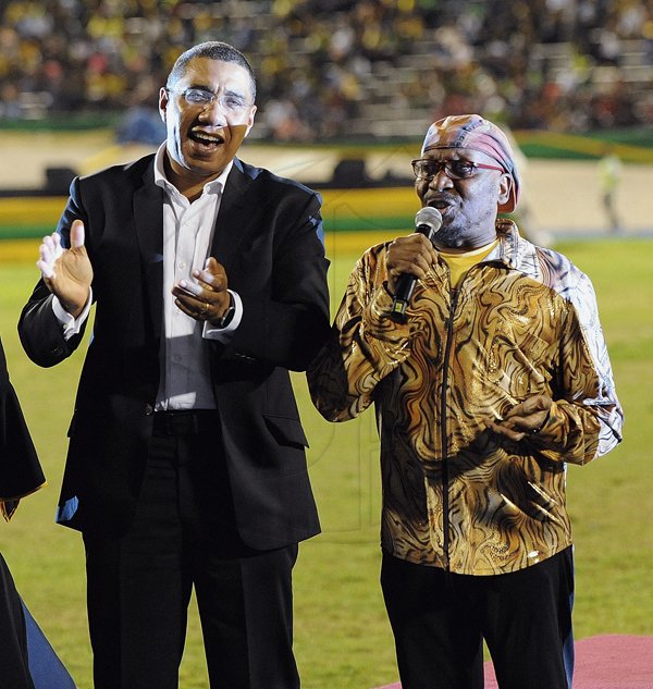 *** Local Caption *** @Normal:Prime Minister Andrew Holness sings to the popular tunes rendered by Dr James ‘Jimmy Cliff’ Chambers, a honouree at the Jamaica 55 Grand Gala on Sunday.