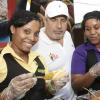 Rudolph Brown/Photographer
BUSINESS
 David Mair, Vice President- Best Dressed Chicken Division a taste of hot dog from left Amanda Foote and Tamara Douglas at the All Jamaican, Grill Off at Hope Gardens on Sunday, June 17-2012