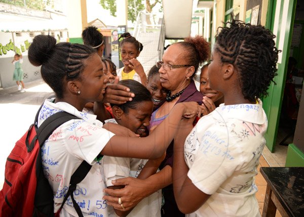 Jermaine Barnaby/Photoghrapher
St Georges Girls school vice principal, Donna Lawson with girls from her school who had passed for traditional high schools in the Gsat exams the results were announced at their school on Thursday June 18, 2015.