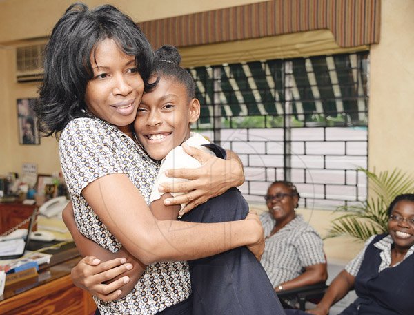 Jermaine Barnaby/Photographer
Hannah Farr (right) is congratulated by her teacher Alecia Sawyers for her GSAT performance which she scored full 100% in all subjects at the Vaz Preparatory school on Wednesday June 17, 2015. Farr will be attending Campion College.