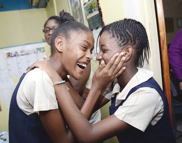 Jermaine Barnaby/Photographer
Hannah Farr (left) and Gavia Christie celebrate their GSAT performance at The Vaz Preparatory school on Wednesday June 17, 2015. Farr who will be attending Campion College, scored 100% on all subjects while Christie scored four 100's and a 99%.