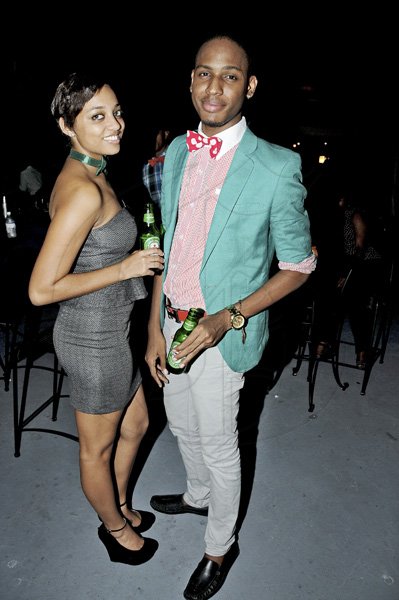 Winston Sill / Freelance Photographer
 Holding their preferred drink of choice, a Heineken ofcourse,  Kimberly Thomas Lee  and Valon Thorpe made a chic style statement for our cameras at Macau Sports bar on Friday.