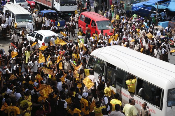 Norman Grindley /Chief Photographer
Holmwood athletes and students march along the streets of Christiana, Manchester in celebration of their eight triumph at the ISSA/GraceKennedy Boys' and Girls' Championships which ended at the National Stadium last Saturday.