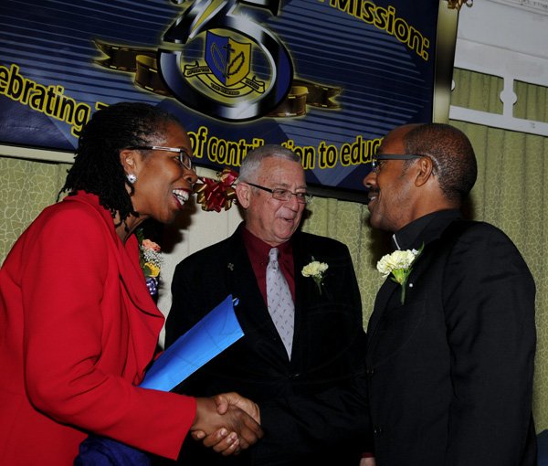 Winston Sill / Freelance Photographer
Holy Childhood High School (HCHS) Long Service Awards Ceremony, held at Knutsford Court Hotel, Ruthven Road on Tuesday night December 18, 2012. Here are Elaine Foster-Allen (left), PS, Ministry of Education; Minister Ronald Thwaites (centre); and Fr. Donald Chambers (right), Chairman, Board of Management, HCHS.