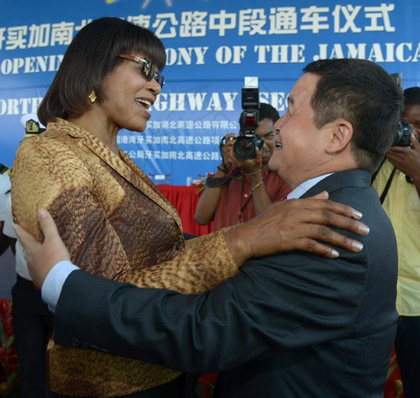 Ian Allen/Staff Photographer
Portia Simpson-Miller left, Prime Minister of Jamaica, greets  Dong Xiaojun right, Ambassador of the People's shortly after the cutting of the Ribbon for the Opening of the North/South Highway Linstead to Moneague Section on Tuesday.