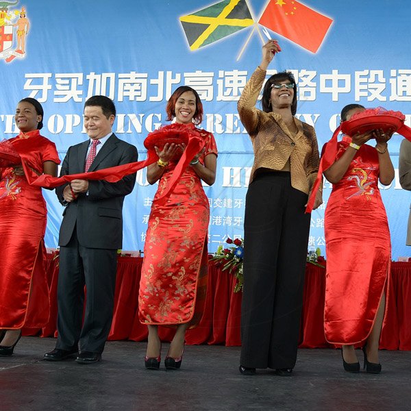 Ian Allen/Staff Photographer
Portia Simpson-Miller second right, Prime Minister and Dong Xiaojun second left, Ambassador of the People's Republic of China to Jamaica, cuts the symbolic ribbon for the Opening of the North/South Highway Linstead to Moneague Section on Tuesday.