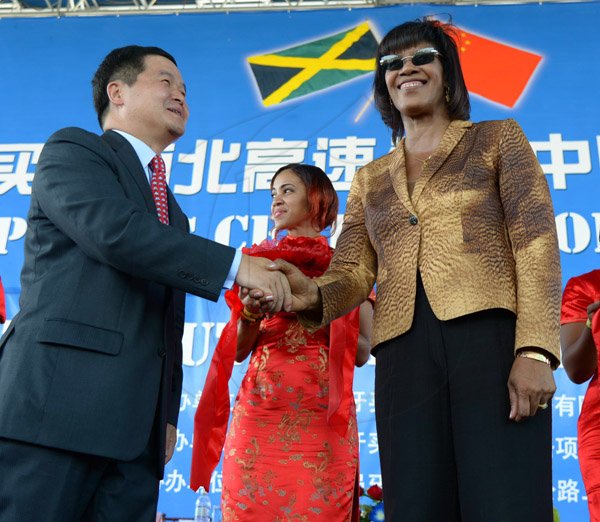 Ian Allen/Staff Photographer
Portia Simpson-Miller right, Prime Minister of Jamaica, shake hands with Dong Xiaojun left, Ambassador of the People's shortly after the cutting of the Ribbon for the Opening of the North/South Highway Linstead to Moneague Section on Tuesday.