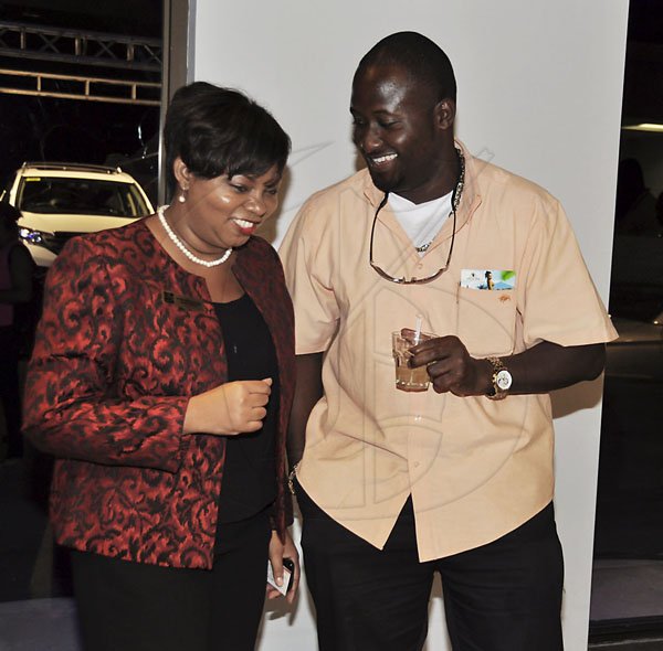 Janet Silvera Photo
 
RBC's manager, Cathay McDonald and Seafood and Poultry's Richard Cole at the ATL Automotives 'Honda CRV' Party at their Bogue industrial centre in Montego Bay
