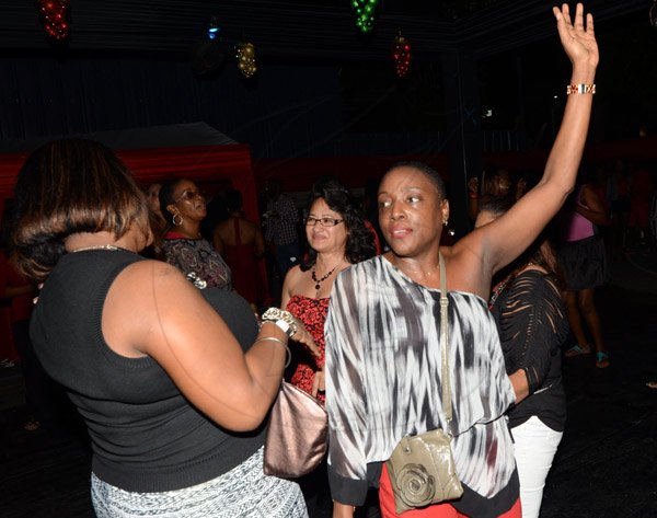 Rudolph Brown/Photographer
Michelle Robinson dancing at the Insurance Association of Jamaica Christmas in November red and black party at the Guardian Life car park in New Kingston on Saturday,  November15-2014.