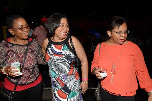 Rudolph Brown/Photographer
Annette Robotham (centre),general manager of College of Insurance and Professional Studies chat with Dorothy Russell Clarke, (right) of BCIC and Heather Bowie at the Insurance Association of Jamaica Christmas in November red and black party at the Guardian Life car park in New Kingston on Saturday,  November15-2014.