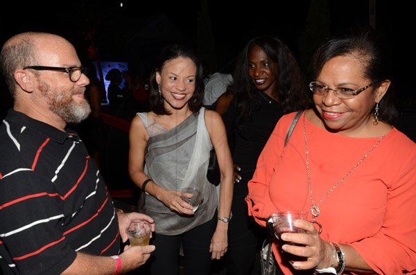 Rudolph Brown/Photographer
Peter Levy chat with Dorothy Russell Clarke, (right) of BCIC and BCIC Marketing Manager Simone Foote at the Insurance Association of Jamaica Christmas in November red and black party at the Guardian Life car park in New Kingston on Saturday,  November15-2014.