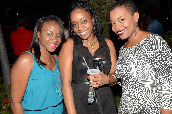 Rudolph Brown/Photographer
From left are Kedeshia Henderson, Shashanna Bernard and Renee Hamilton at the Insurance Association of Jamaica Christmas in November red and black party at the Guardian Life car park in New Kingston on Saturday,  November15-2014.
