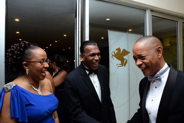 Winston Sill/Freelance Photographer
The Institute of Chartered Accountants of Jamaica (ICAJ) Annual Awards Banquet, for the presentation of ICAJ Distinguished MemberAward to Eric A. Crawford; and the Launch of 50th Anniversary Celebrations, held at the Jamaica Pegasus Hotelm New Kingston on Thursday night December 4, 2014.  Here are Rosemarie Heaven (left), Executive Director, ICAJ; W. Billy Heaven (centre); and Dennis Chung (right), President, ICAJ.
