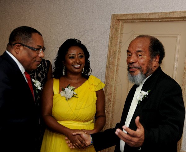 Winston Sill / Freelance Photographer
The Incorporated Masterbuilders Association of Jamaica (IMAJ) 60th Anniversary  Awards Banquet, held at the Jamaica Pegasus Hotel, New Kingston on Saturday night March 2, 2013. Hereare Minister Anthony Hylton (left); Mrs. Anthony Hylton (centre); and Carvel Stewart (right), President, IMAJ.