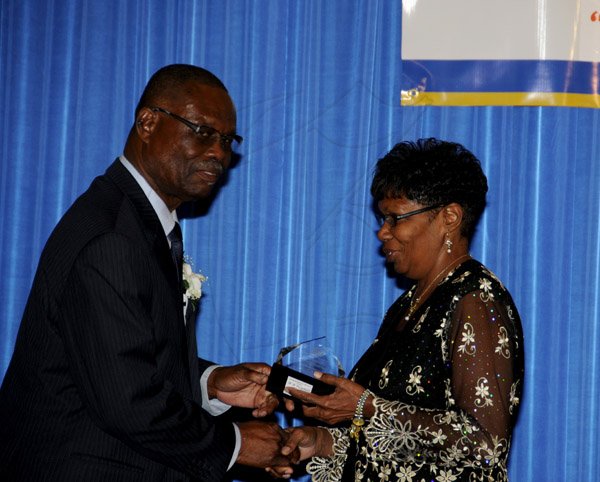 Winston Sill / Freelance Photographer
The Incorporated Masterbuilders Association of Jamaica (IMAJ) 60th Anniversary  Awards Banquet, held at the Jamaica Pegasus Hotel, New Kingston on Saturday night March 2, 2013. Here Hugh Burton (left); makes a presentation to Lavern Scarlett (right) for 31 years of service.