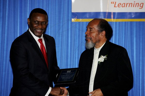 Winston Sill / Freelance Photographer
The Incorporated Masterbuilders Association of Jamaica (IMAJ) 60th Anniversary  Awards Banquet, held at the Jamaica Pegasus Hotel, New Kingston on Saturday night March 2, 2013. Here are Cecil Foster (left), Managing Director of FosRich Energy Limited; and Carvel Stewart (right), President, IMAJ.