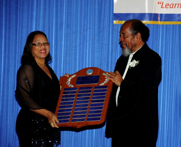 Winston Sill / Freelance Photographer
The Incorporated Masterbuilders Association of Jamaica (IMAJ) 60th Anniversary  Awards Banquet, held at the Jamaica Pegasus Hotel, New Kingston on Saturday night March 2, 2013. Here Marcia Rowe-Amonde (left), Director and Principal of HEART/NTA collecting the President's Award on behalf of Vocational Training Development Institute (VTDI) from Carvel Stewart, President, IMAJ.