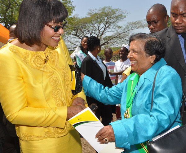 Jermaine Barnaby/Photographer
Enid Bennett (right) was a face of excitement as she was greeted by Prime Minister Portia Simpson Miller at the Annual Independence Day Ceremony at  King's House on Wednesday, August 6, 2014.