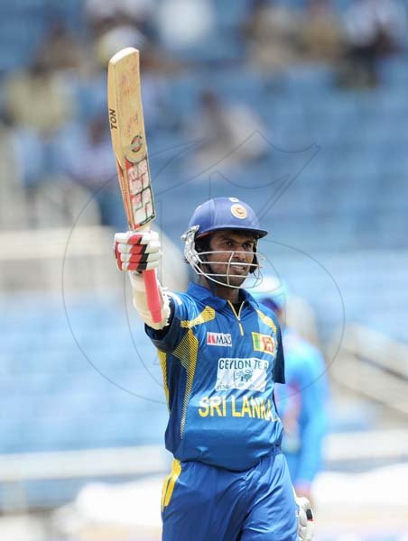 Ricardo Makyn/Staff Photographer
Sri Lanka's Upal Tharanga raises his bat to celebrate his century against India in the CELKON Tri-Nation Series one-day international match at Sabina Park yesterday. Tharanga made 174 not out in Sri Lanka's 348 for one off 50 overs.