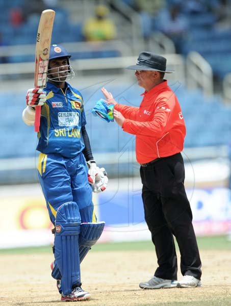 Ricardo Makyn/Staff Photographer
Sri Lank'as Tharannga  raises His Bat to celebrate His century against India at Sabina Park on Tuesday 2.7.2013