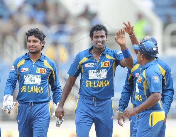 Ricardo Makyn/Staff Photographer
Sri Lanka's players frm left Kumar Sangakara,Angello Mathews Captain celebrate a Wicket against India at Sabina Park on Tuesday 2.7.2013