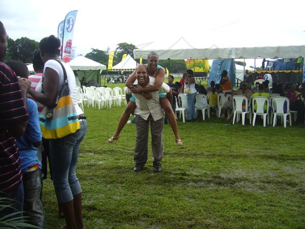 Paul Williams/Gleaner Writer
Roti Festival
Whoii donkey! And who said chivalry is dead is a liar. Paul Gaynor keeps it alive as he navigates through the mud at the National Council for Indian Culture in Jamaica's Indian Arrival Day and Roti Festival on Sunday, May 6, at Chedwin Park, St Catherine.