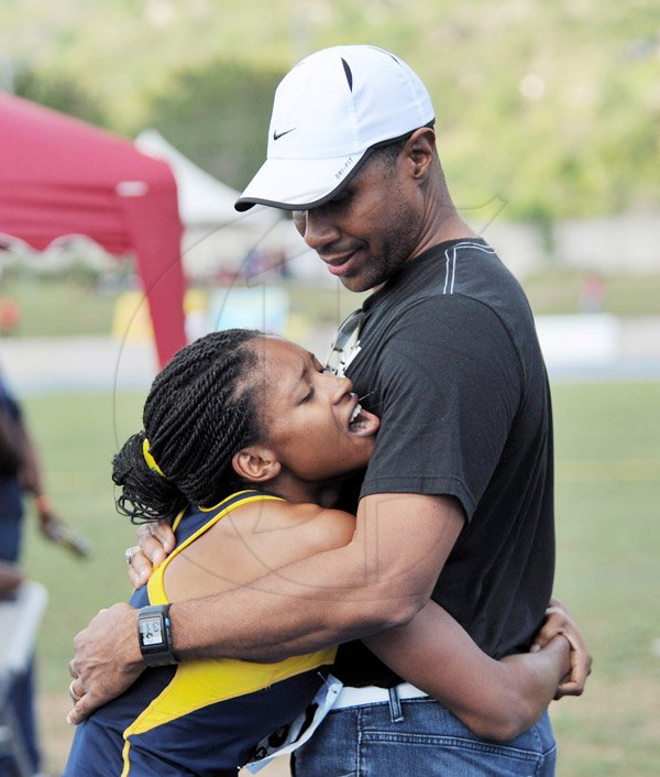 Ian Allen/Staff Photographer
Semoya Campbell (left) from the University of Technology (UTech) hugs Bruce James, President of the UTech-based MVP Track Club shortly after she won the women's 1500m finals at the 2014 VMBS Intercollegiate Track and Field Championships at the University of West Indies/Usain Bolt Track on Saturday.