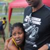 Ian Allen/Staff Photographer
Semoya Campbell left, from Utech collapse on Bruce James  right, President of MVP Track Club shortly after she won the women's 1500m finals at the VMBS Intercollegiate Track and Field Championships 2014 at the UWI/Usain Bolt Track.
