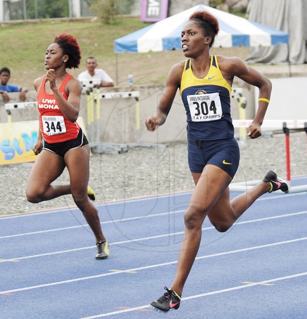 Ian Allen/Staff Photographer
Rushell Clayton (left) of University of the West Indies,  Mona got the better of Jenieve Russell of the University of Technology in the 400m hurdles final at the Victoria Mutual Building Society(VMBS) Intercol Track and Field Championships 2014 at UWI/Usain Bolt Track.